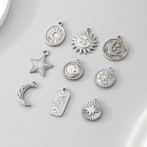 Detailed view of nine stainless steel celestial charms including sun, moon, and star motifs