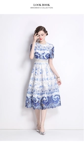 Close-up of elegant hollow-out lace fabric with blue floral patterns on a midi dress