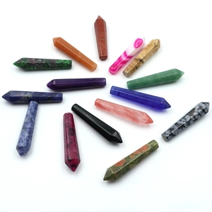 Various hexagonal natural crystal pillars like amethyst and obsidian on white background