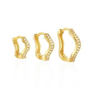 Three wave-shaped gold earrings with inlaid crystals in a gradient set with huggie clasp