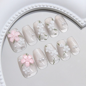 Elegant cat-eye press-on nails set with 3D floral petals and mini pearls in soft grey