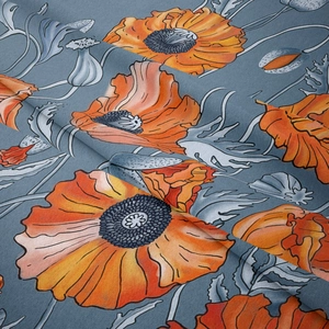 Detailed close-up showing soft fabric texture and red poppy flowers on mist blue tapestry