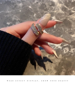 Detailed view of a gold plated multi-layer wrap ring featuring sparkling white pavé diamonds