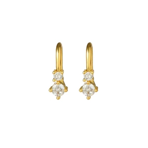 Detail of gold hoop earrings featuring double round-cut cubic zirconia in prong setting