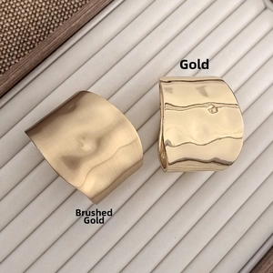 Detail view showing a comparison of gold polished and brushed metal jewelry finishes