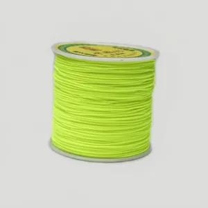 Close-up of fluorescent yellow 0.8mm nylon cord roll for DIY jewelry and braiding