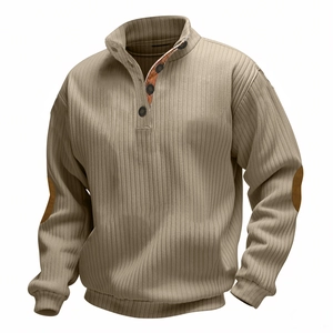 Detail of khaki ribbed knit sweater with buttoned neck and brown elbow patches