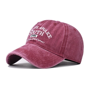 Close-up of vintage washed cotton baseball cap featuring high-quality white YOUTH embroidery