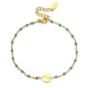 Detail of gold stainless steel bracelet featuring turquoise beads and Yin Yang charm
