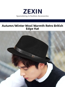 Detail of wool fedora hat with dark leather band and metallic M buckle decoration