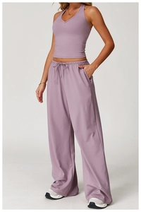 Detail of high-waist wide-leg violet sports trousers with drawstring and side pockets