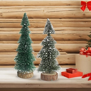 Close-up of two mini Christmas trees with white snow effect and natural round wooden bases