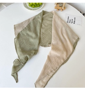 Detailed texture of Morandi green and beige cotton-linen scarf with wavy lace edges