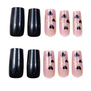Valentine style press-on nails with black gold heart designs and glitter finish