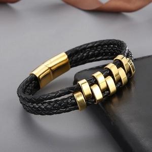 Detail of multi-layer woven leather bracelet with golden magnetic buckle and metal rings