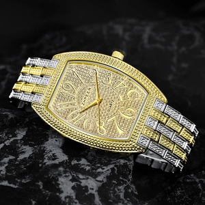 Macro shot of luxury iced-out tonneau quartz watch on dark stone with rhinestone details