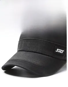 Close-up of dark grey textured denim fabric and curved brim of the vintage flat cap