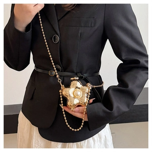 Détail d'un mini sac fleur doré avec perle centrale et bandoulière en chaîne dorée