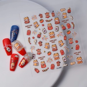 Macro shot of 3D lunar new year nail stickers with golden dragon and lucky symbols