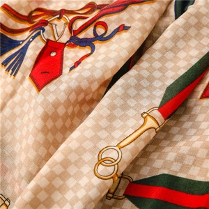 Macro shot of khaki checkered fabric texture with horse carriage pattern and silk ribbons