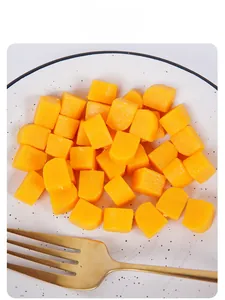 Macro shot of miniature simulation mango cubes in a ceramic plate for dollhouse kitchen