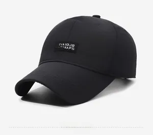 Close-up of black baseball cap featuring lion logo patch and fine cotton twill texture