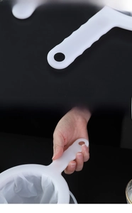Detail of ergonomic handle and hanging hole on ultra-fine mesh kitchen strainer