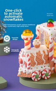 Detail of Christmas gingerbread train snow globe with LED lighting and golden glitter