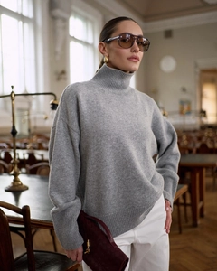 Detailed knit texture and soft fabric of grey turtleneck sweater for women in library