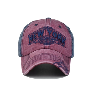 Close-up of vintage New York 1985 embroidery on distressed navy and maroon cotton cap