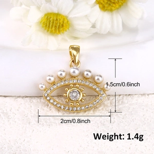 Detail view of gold evil eye pendant with pearls and crystals including size measurements