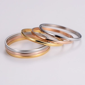 Minimalist hinged bangles in gold, silver, and rose gold with polished mirror finish