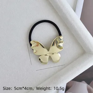 Detail of golden butterfly hair tie with size dimensions 5cm x 4cm and weight 10.5g