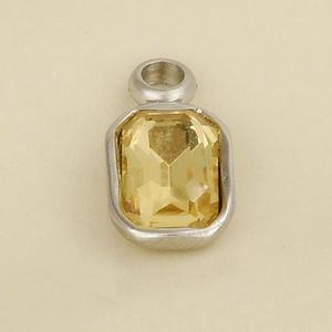 Detailed macro view of an emerald-cut yellow crystal pendant in a silver steel frame