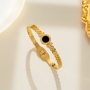 Golden stainless steel bangle with black roman numeral disk and LOVE engraving