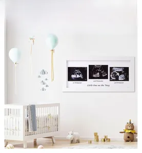 Three-opening white wooden baby sonogram frame with 1st, 2nd, and 3rd trimester labels
