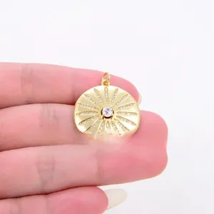 Detailed close-up of a sunburst pendant with sparkling micro-pave crystals and center zircon