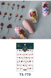 Macro detail of tulip and floral nail art stickers with vintage red and yellow patterns