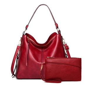 Dark red leather tote bag set including large shoulder bag and matching wristlet clutch