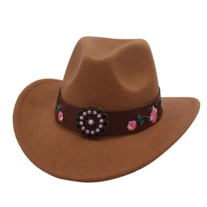 Detail of brown wool felt cowboy hat featuring leather band with pink floral embroidery
