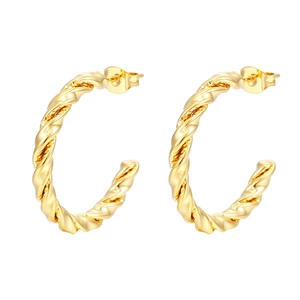 Macro shot of twisted hoop earrings in shiny gold finish with sleek spiral texture