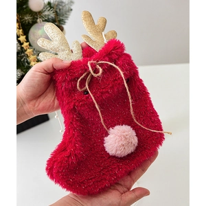 Red plush Christmas reindeer stocking gift bag with gold glitter antlers and fuzzy pom-poms