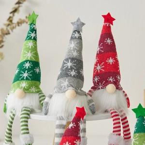Three Christmas plush gnomes with striped long legs and glowing star hats on white stands