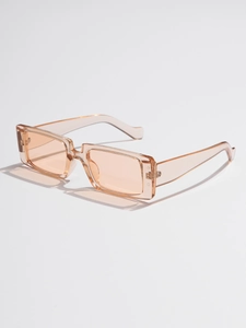 Macro shot of stylish square sunglasses in transparent peach pink with Y2K retro frame