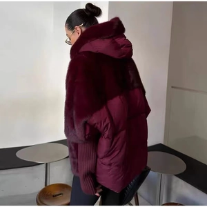 Detail of burgundy faux fur jacket featuring knit ribbed cuffs and large lapel collar