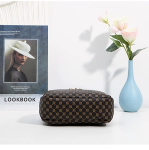 Detailed bottom view of brown geometric print shoulder bag with soft PU leather texture
