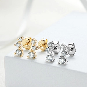 Detailed view of gold and silver S925 sterling silver stud earrings with moissanite zircons