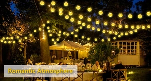 Outdoor solar string lights with G40 globes creating a romantic garden dinner atmosphere
