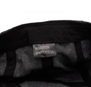 Dettaglio dell'etichetta interna del basco in denim lavato, 80% cotone e 20% poliestere
