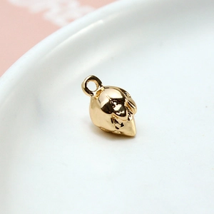 Close-up of a golden fox-shaped DIY metal pendant on a white ceramic plate